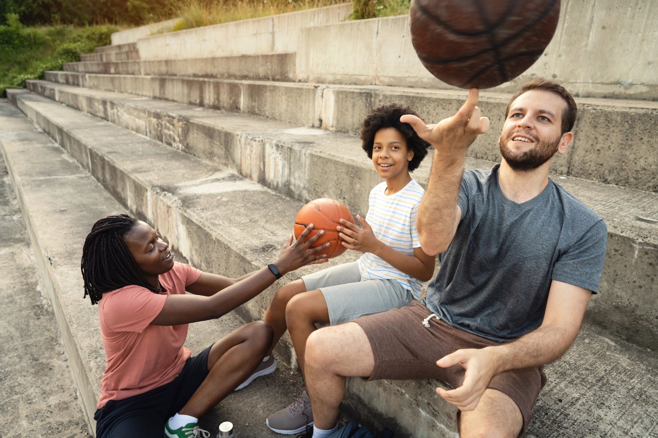 Mentor and youth taking a break on a basketball court