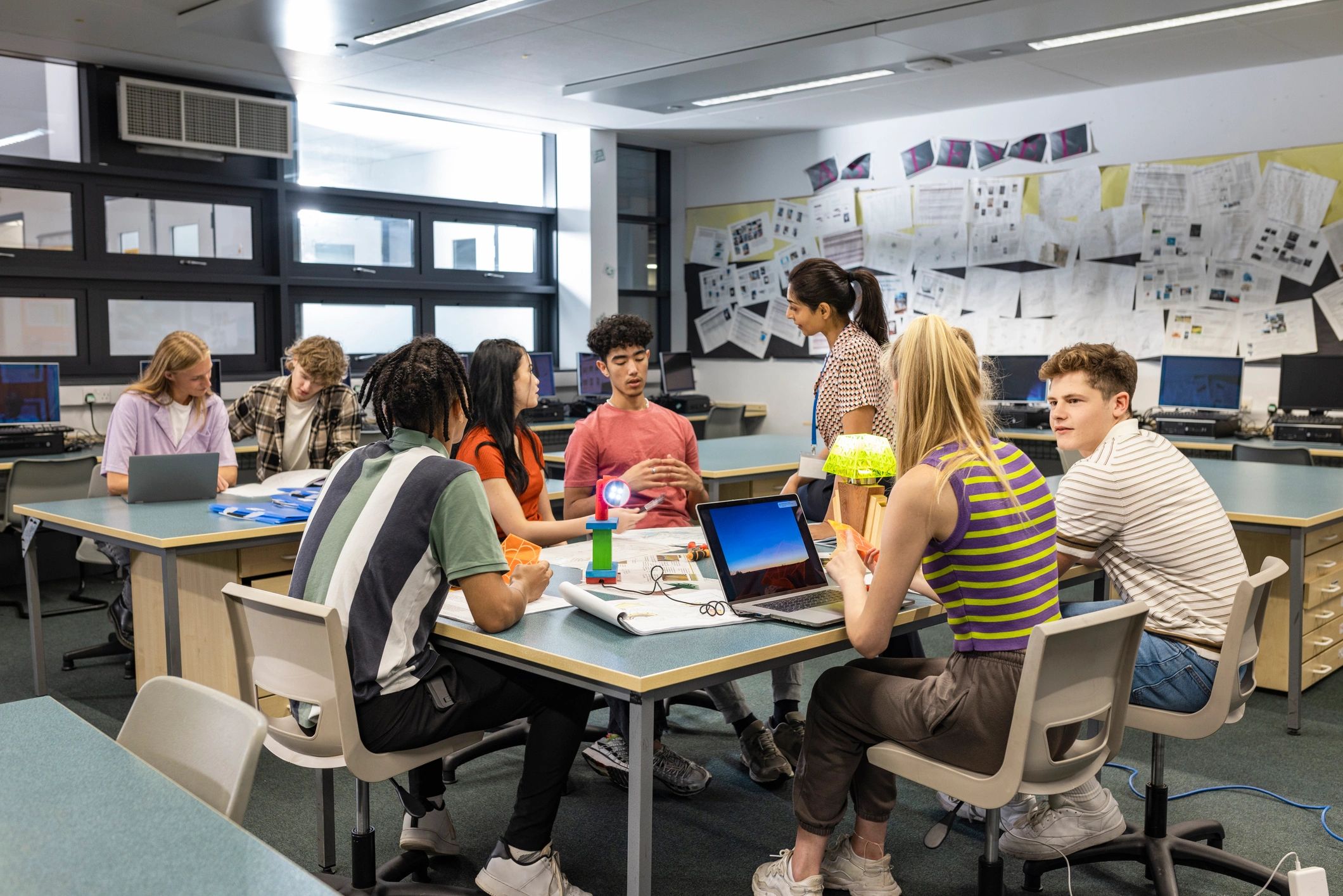 Students and a teacher collaborating in a classroom