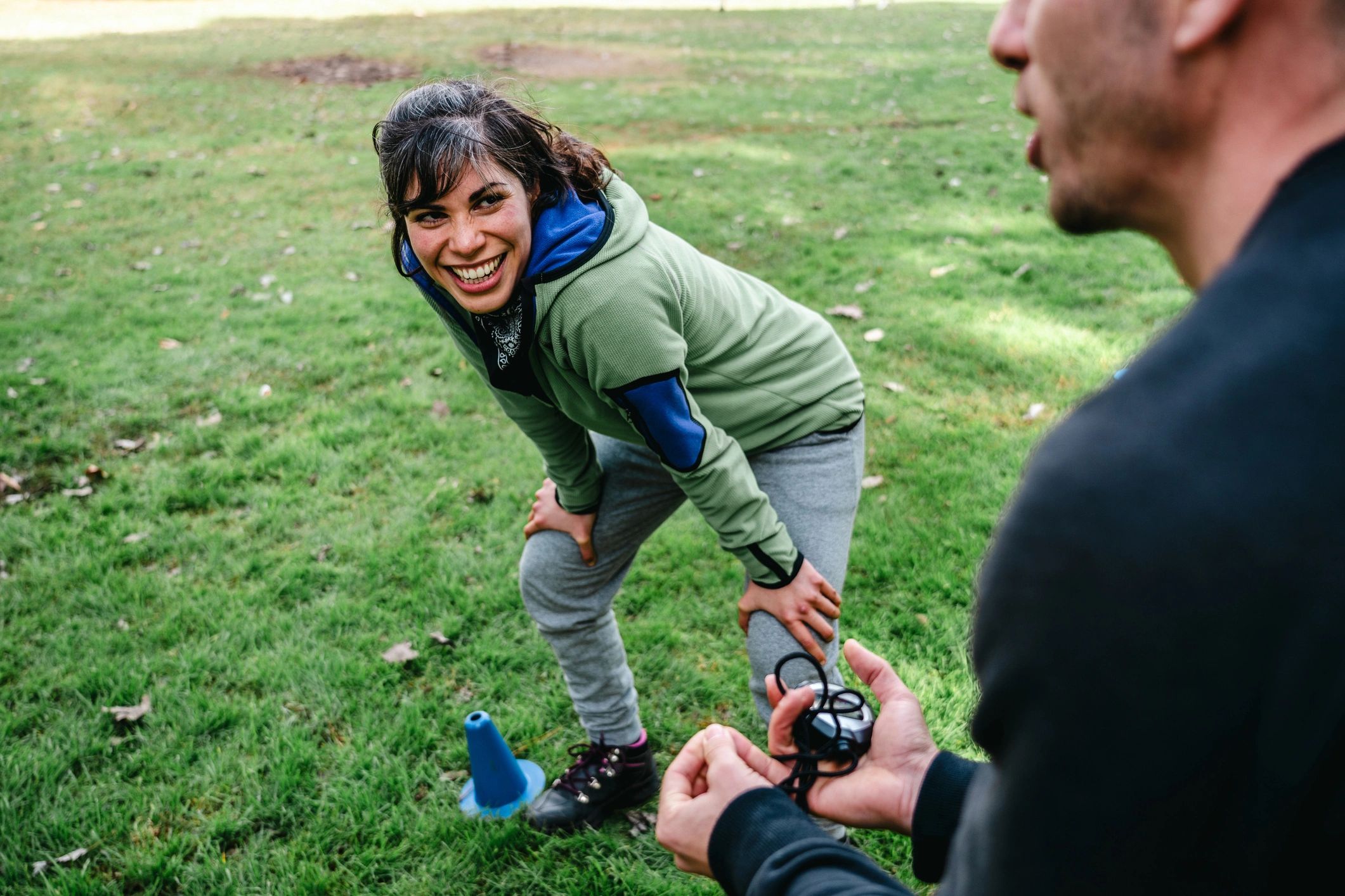 Mentor speaking with a young athlete during an outdoor training session