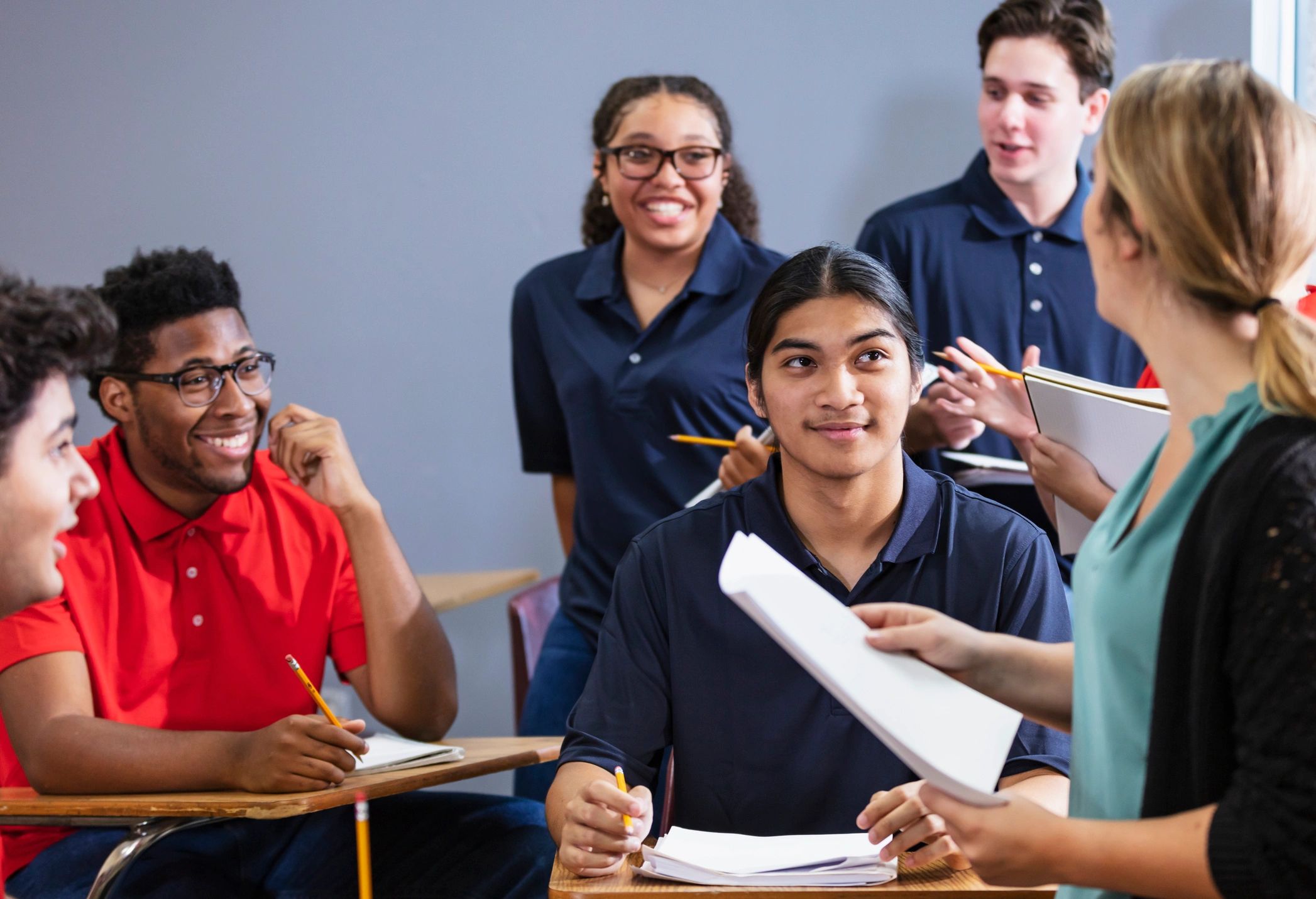 Teacher leading a group discussion with teens