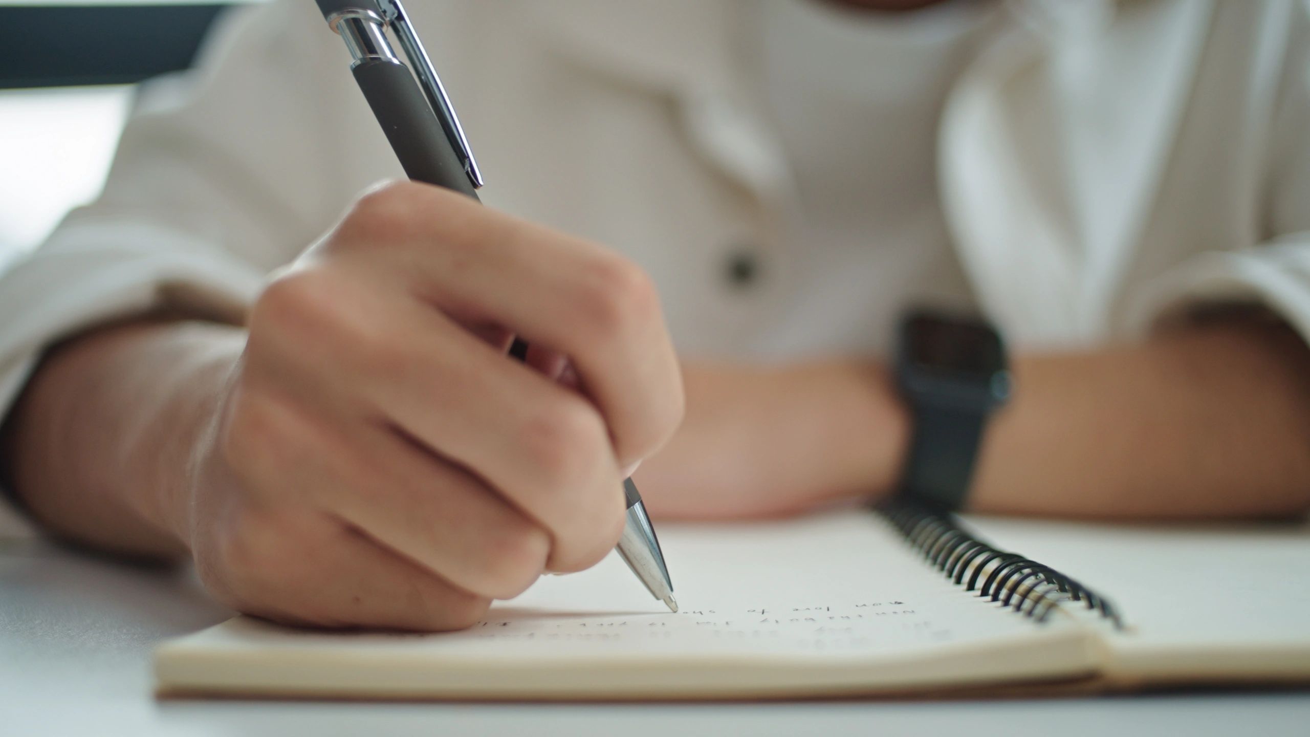 Participant writing notes at a table