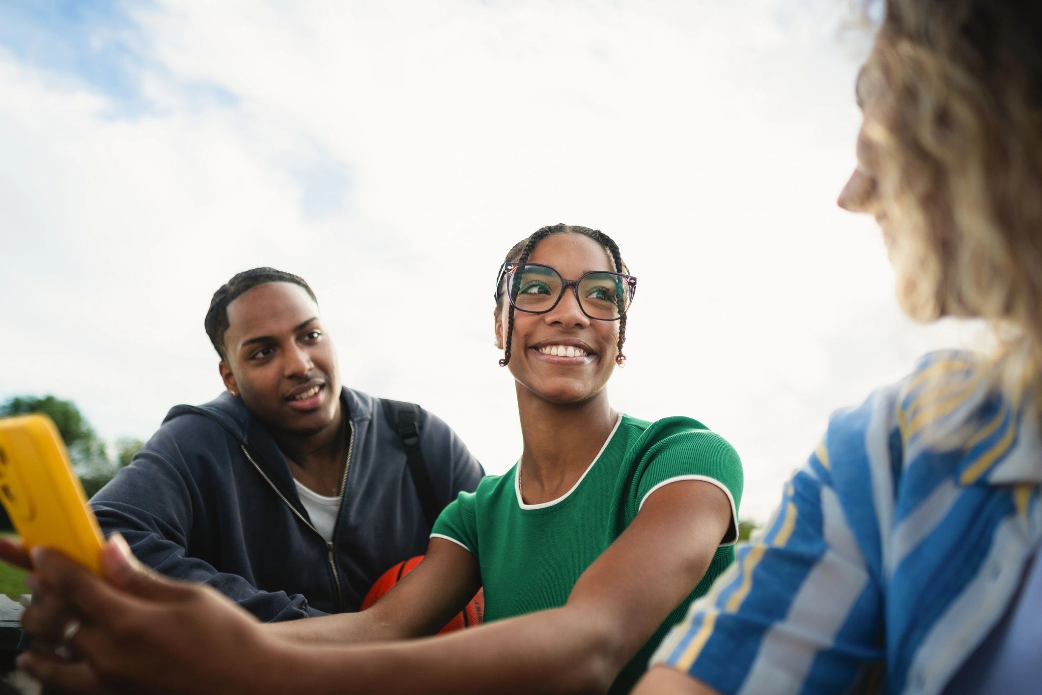 Group of teens and young adults spending time together outdoors