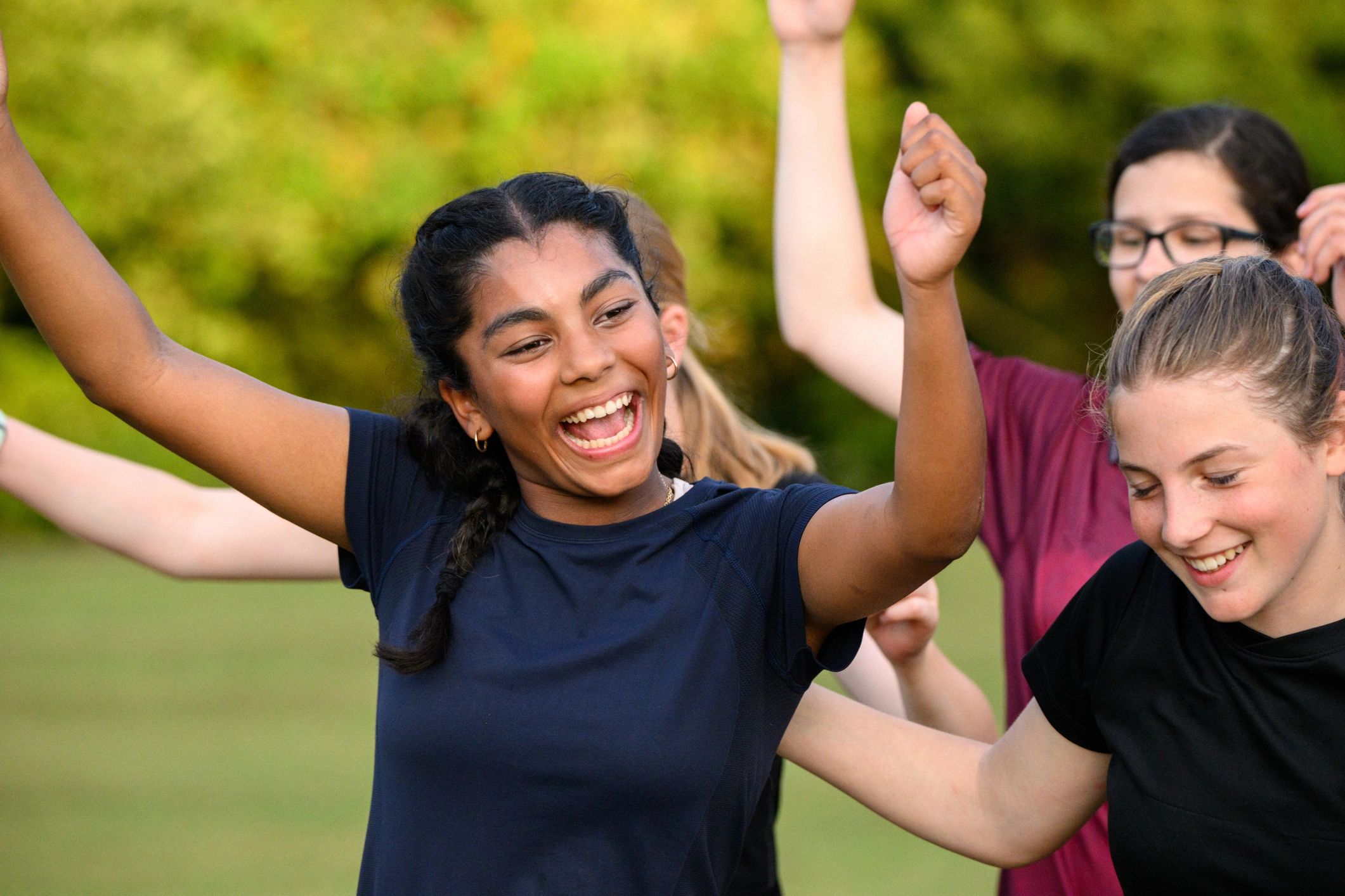 Teen athletes celebrating together after a play