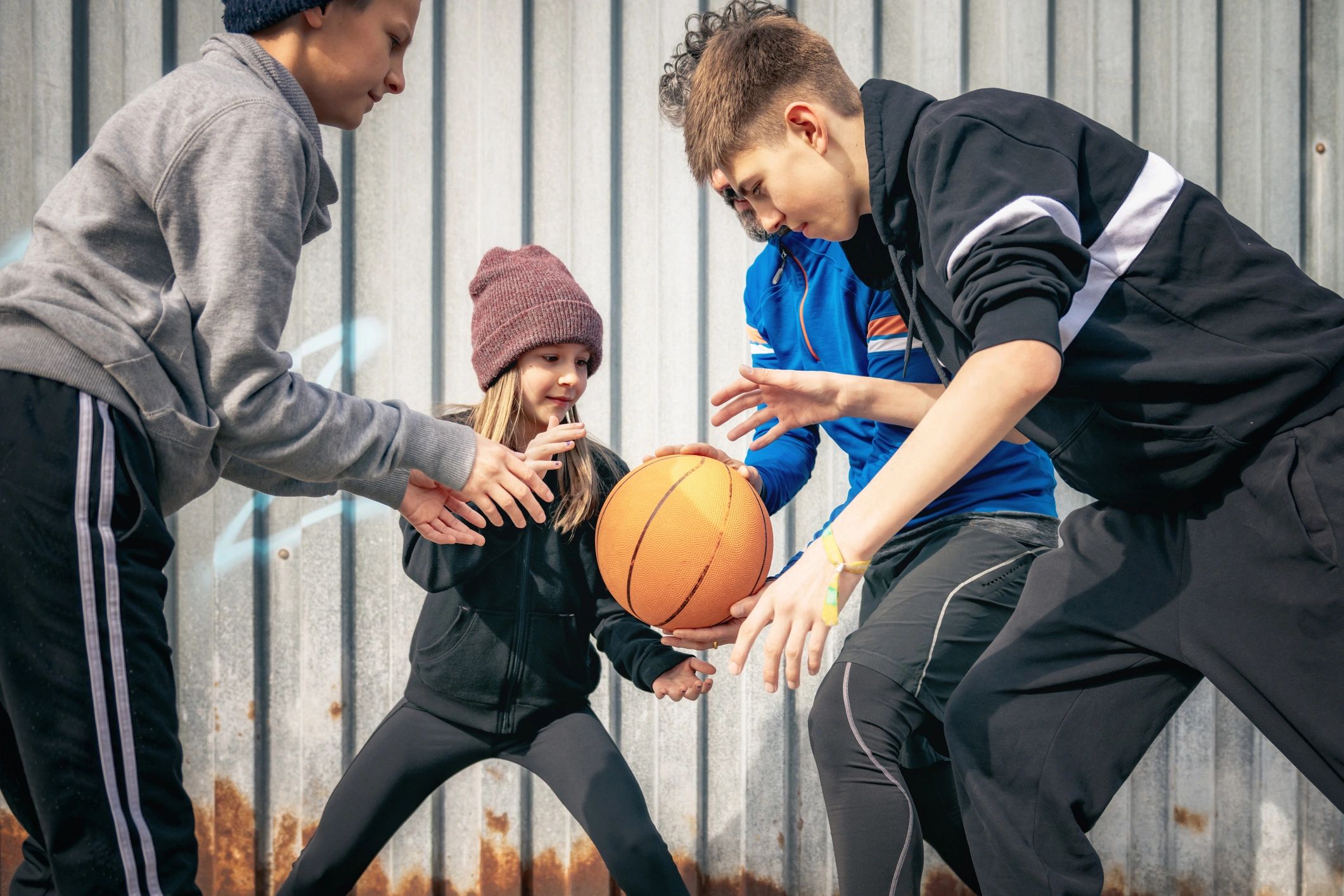 Youth playing basketball outdoors